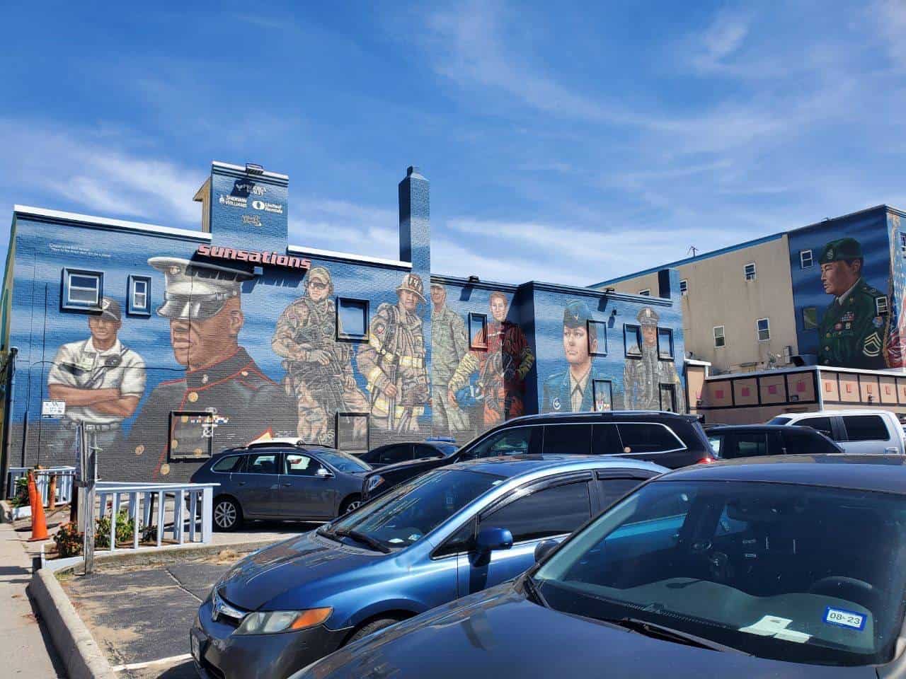 Cars parked near a building with mural in Virginia.