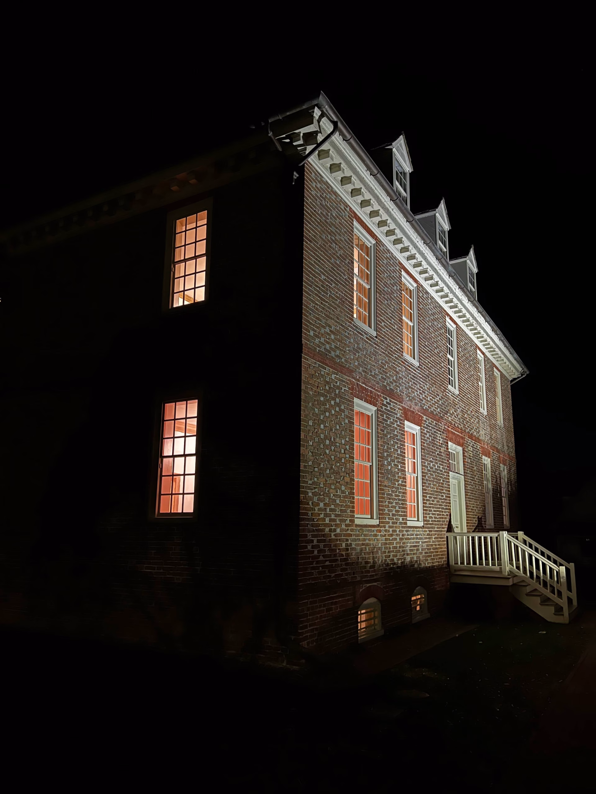 An old brick building in Virginia at night.