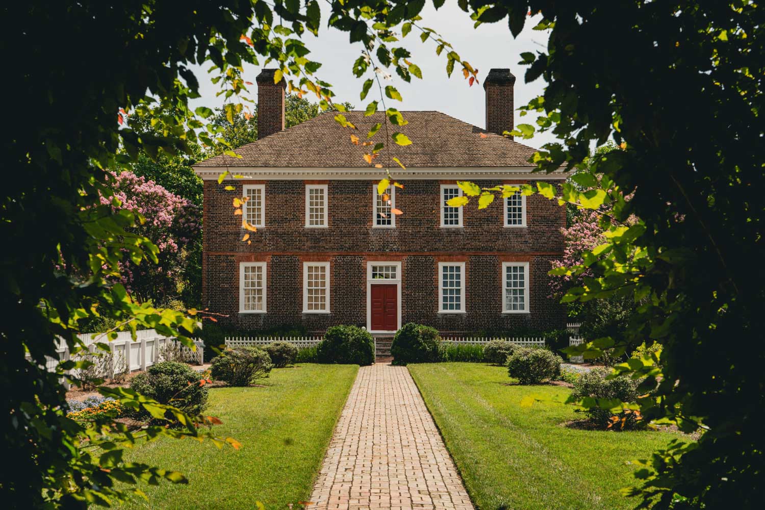 An old brick house with garden in Colonial Williamsburg, Virginia.
