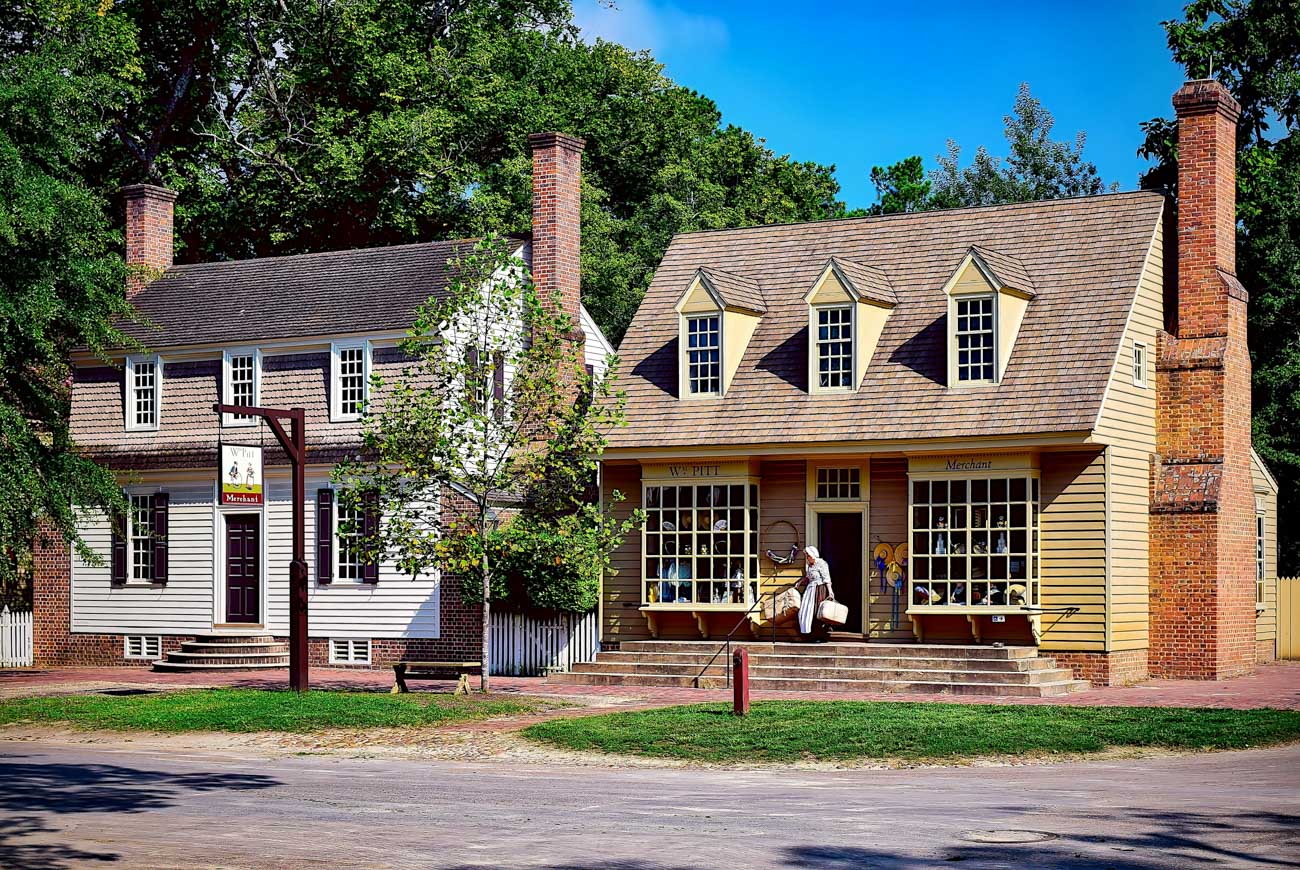 Old wooden buildings with brick chimneys in Williamsburg, Virginia.