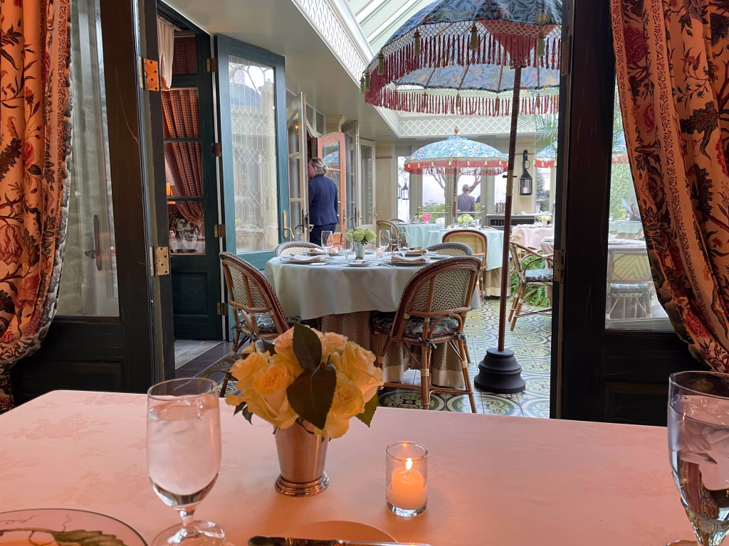 Tables with flowers, candles, glass, and plates at The Inn at Little Washington.