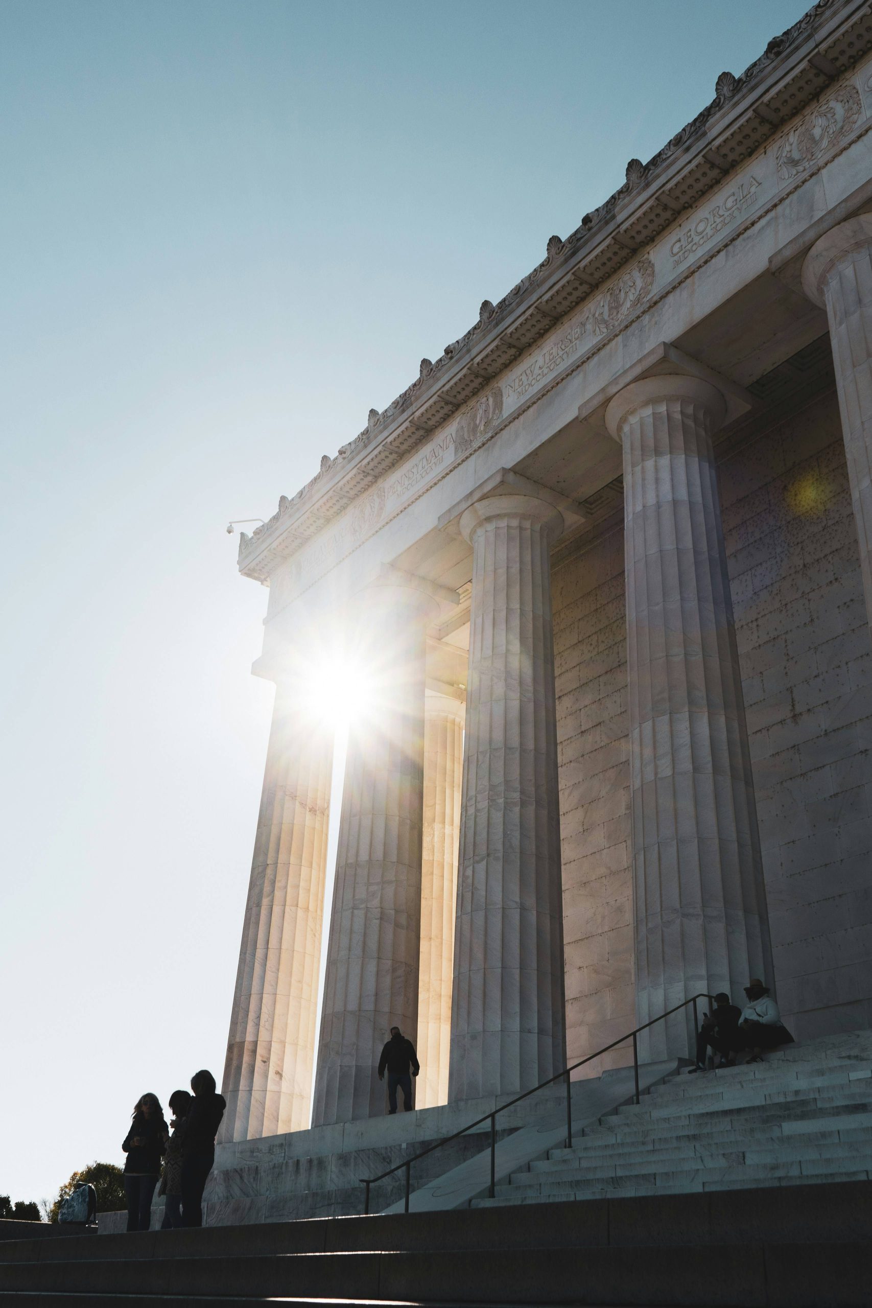 Sunlight peeking through the columns of a building in Washington DC.