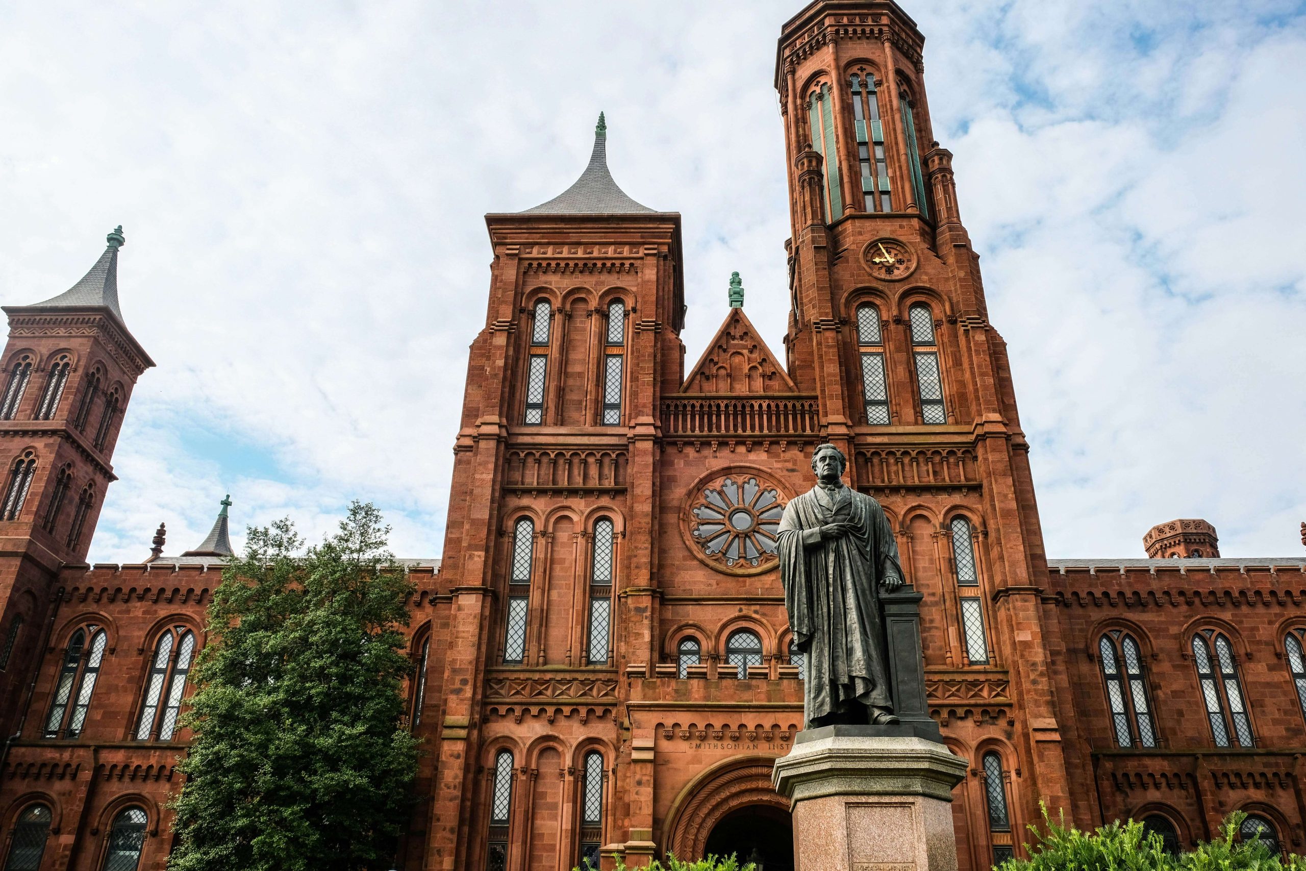 The Smithsonian Castle in Washington DC with statue.