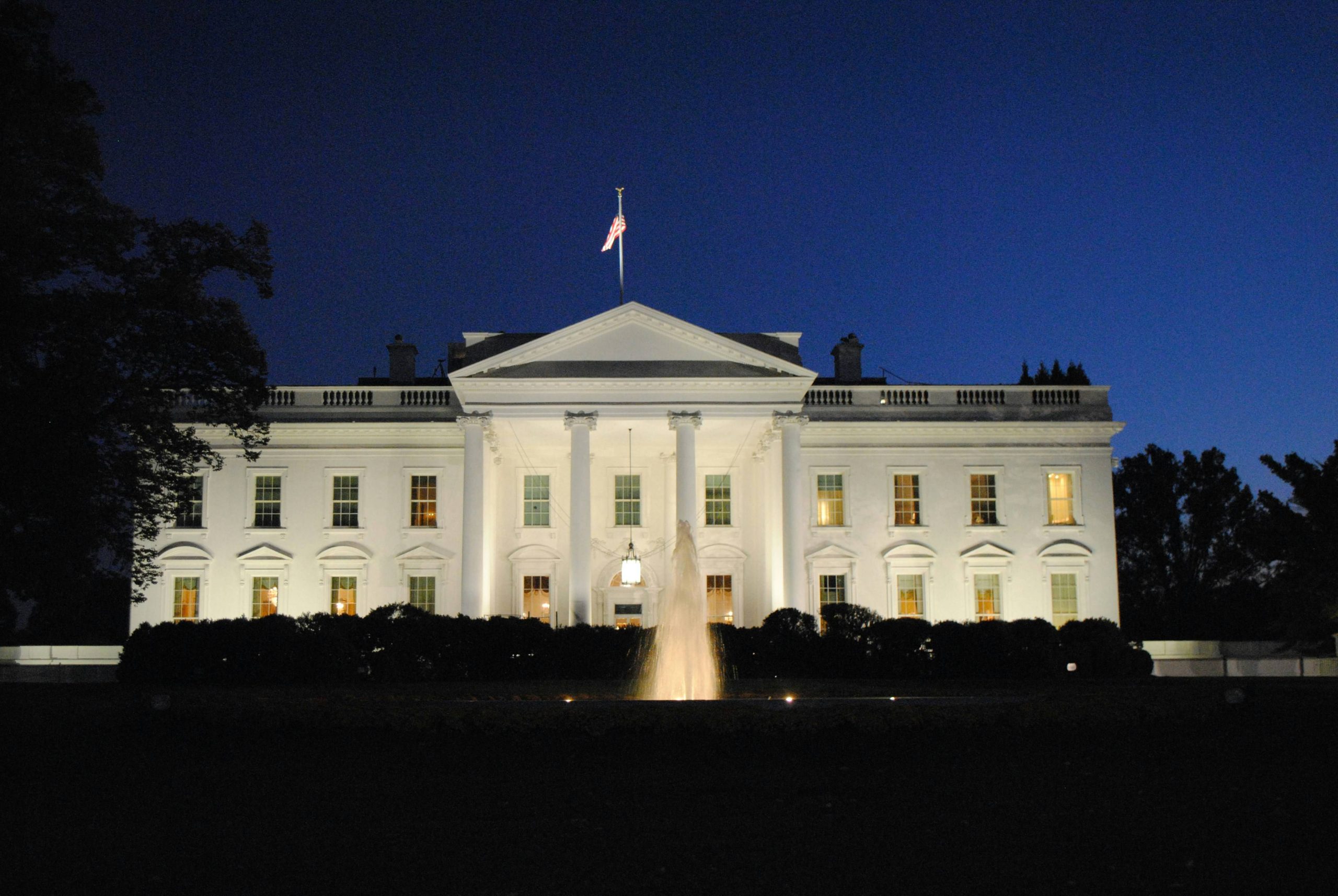 The White House with fountain in Washington DC at night.