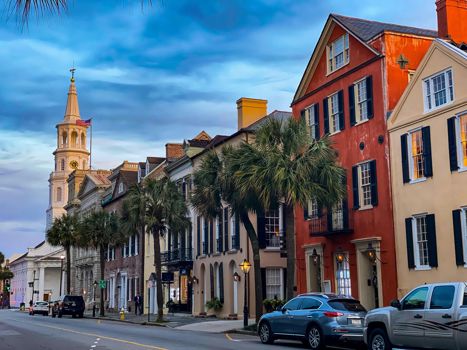 The town in South Carolina with cars parked on the road side.