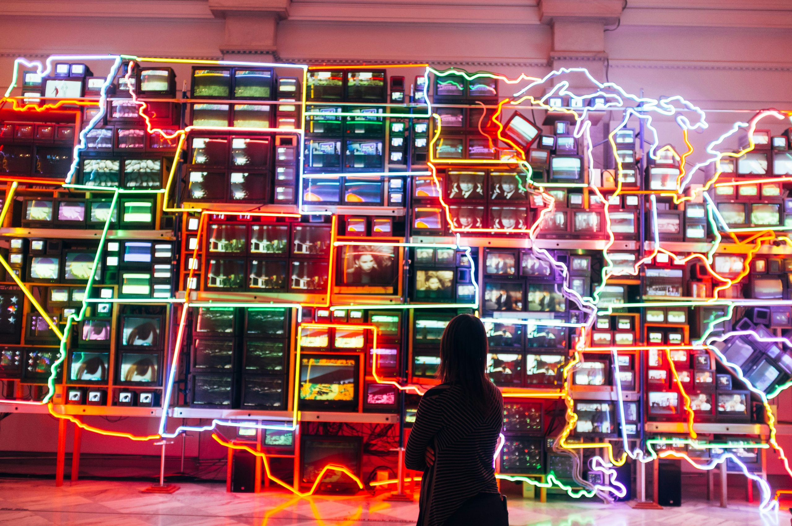 A person looking at an artwork inside a museum in Washington DC.