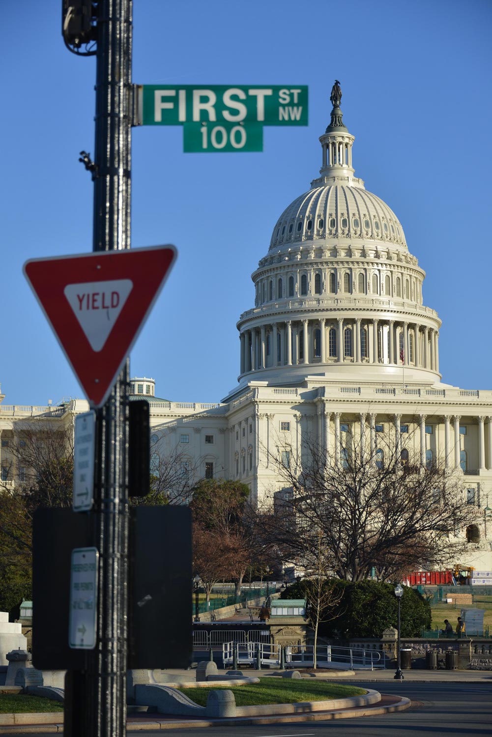 The capitol building in Washington DC seen from a street view.