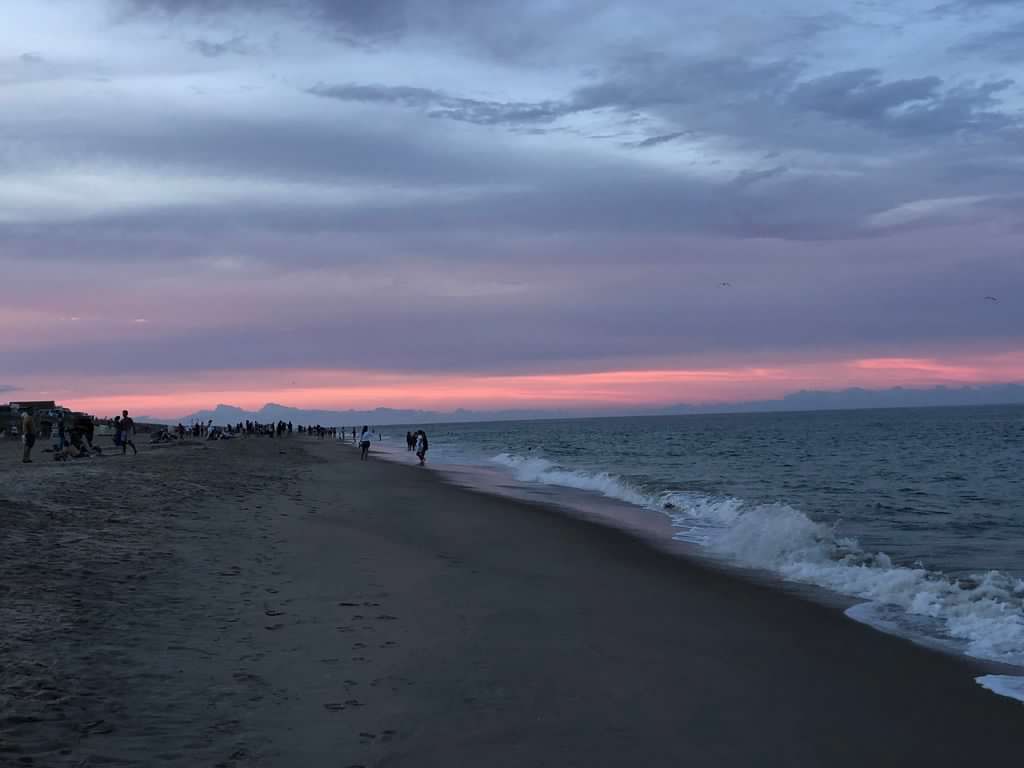 A beach at sunset, the sky about to darken.