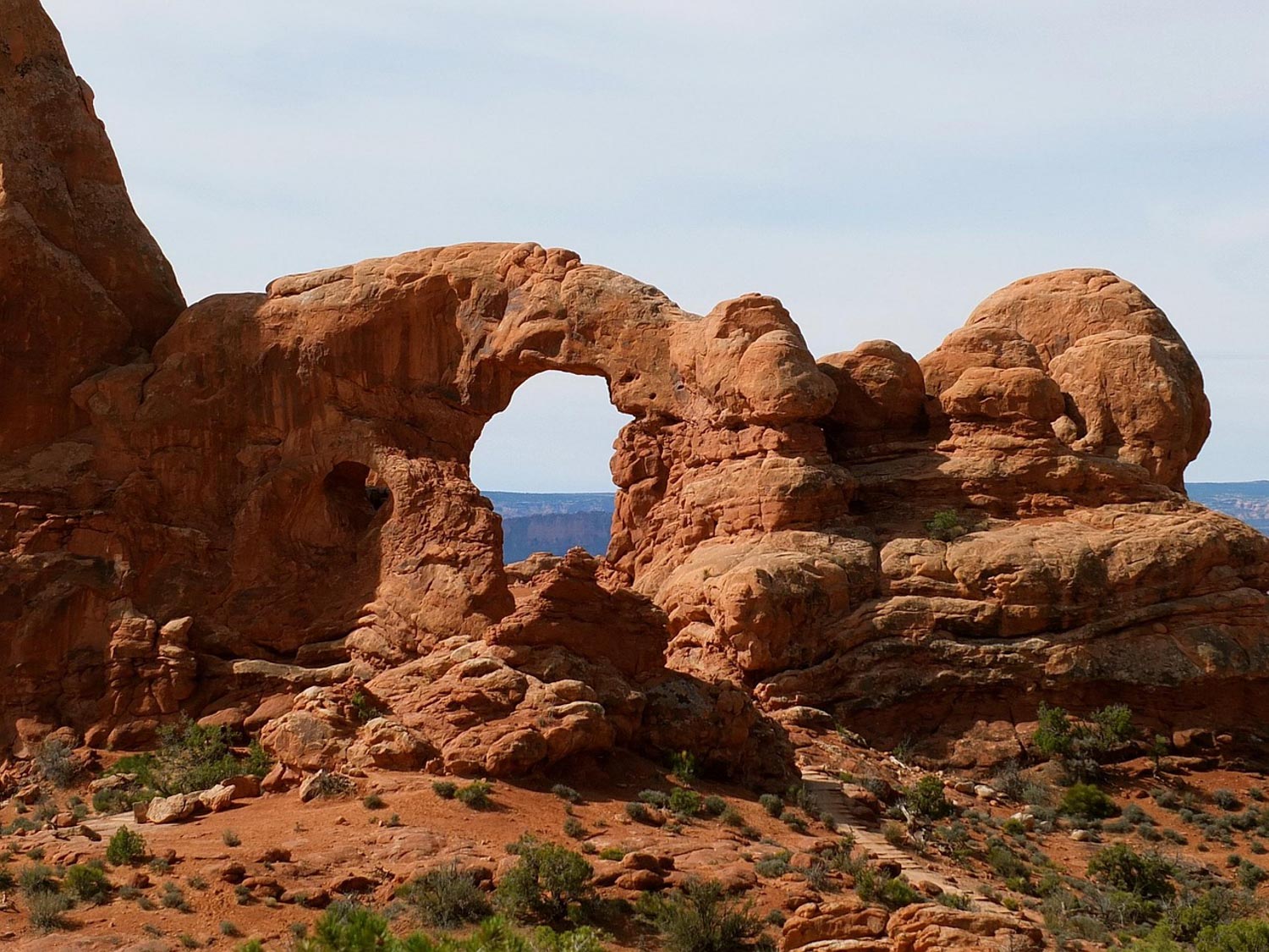 Arch-shaped red rock formations.