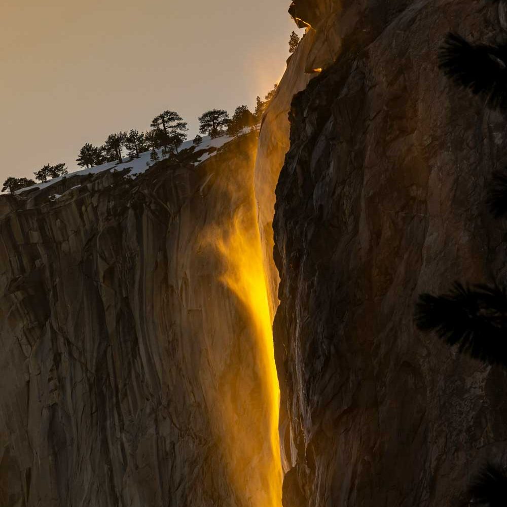 A waterfall with illusion of yellow light flame.