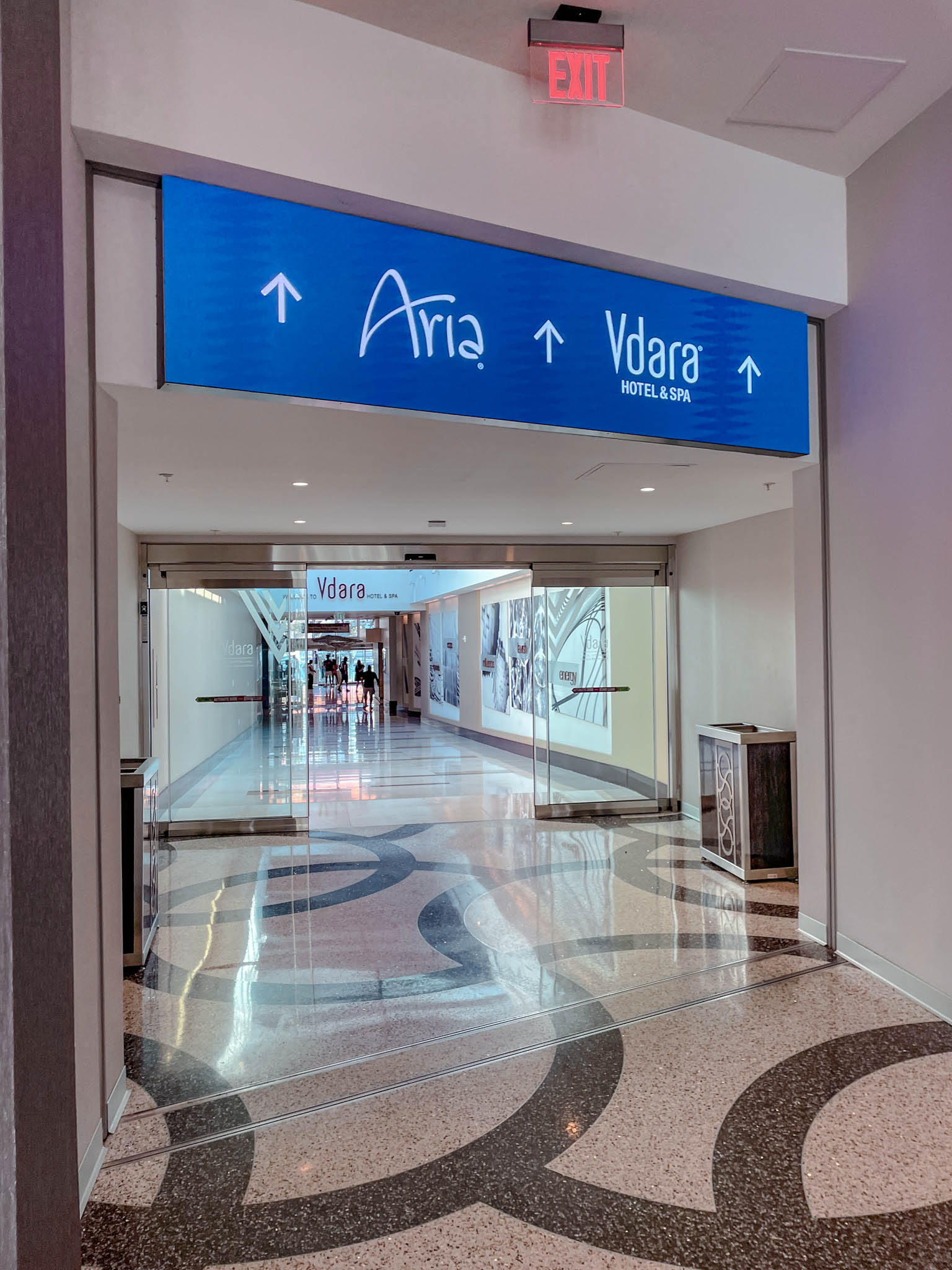 The walkway with signs that lead to Aria and Vdara.