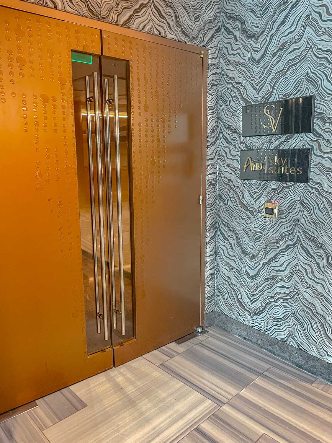 Carpeted room with two doors.