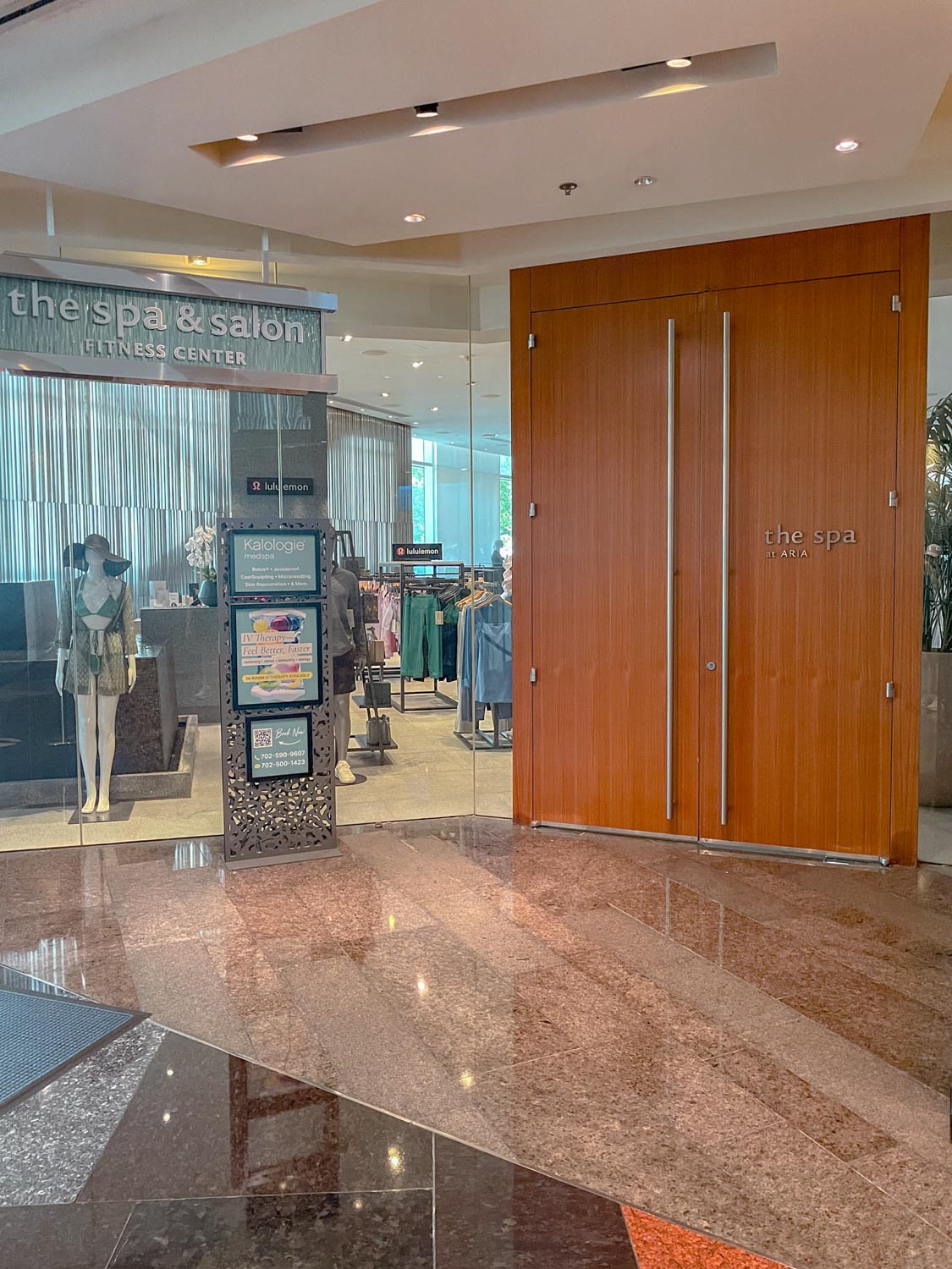 The entrance of a Las Vegas hotel spa with big wooden doors.