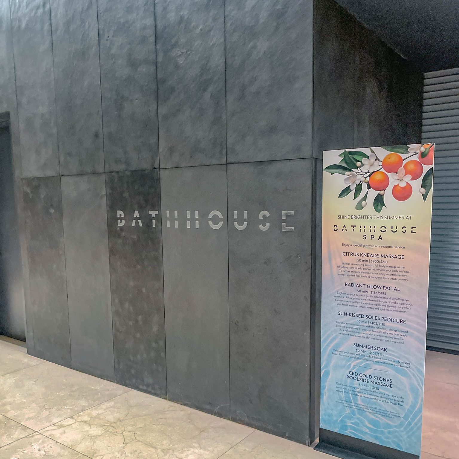 The entrance to a spa with black stone walls.