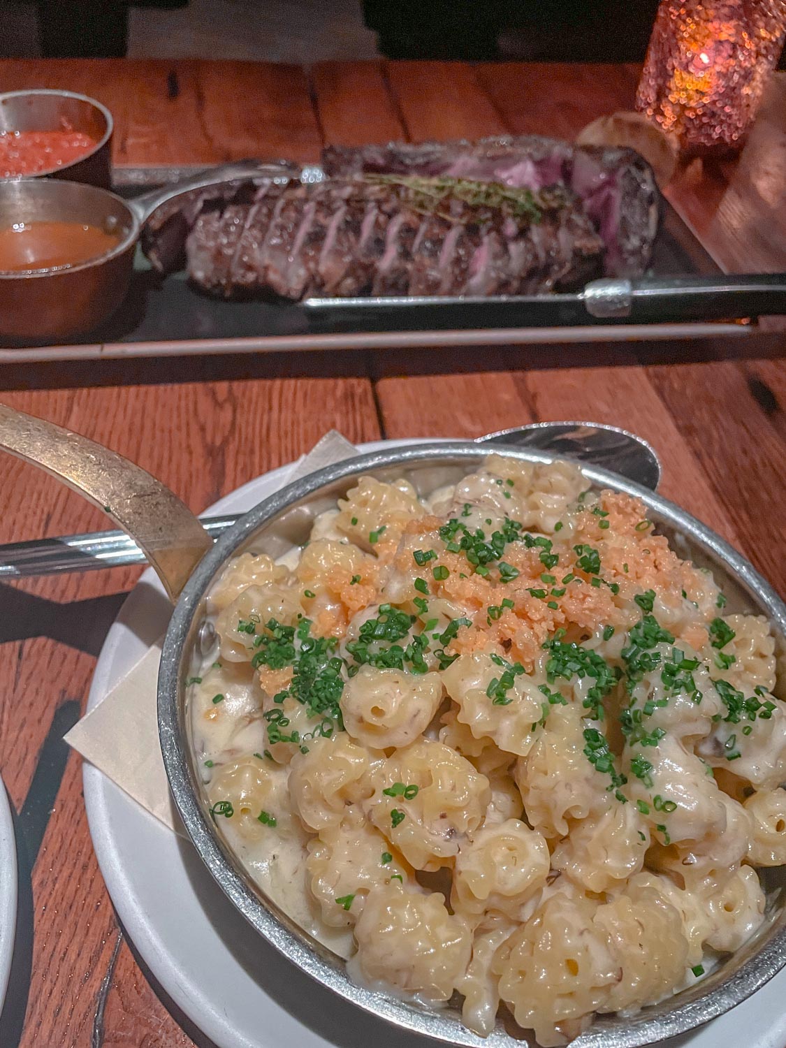 A bowl of food and steak on a table inside a Las Vegas restaurant.