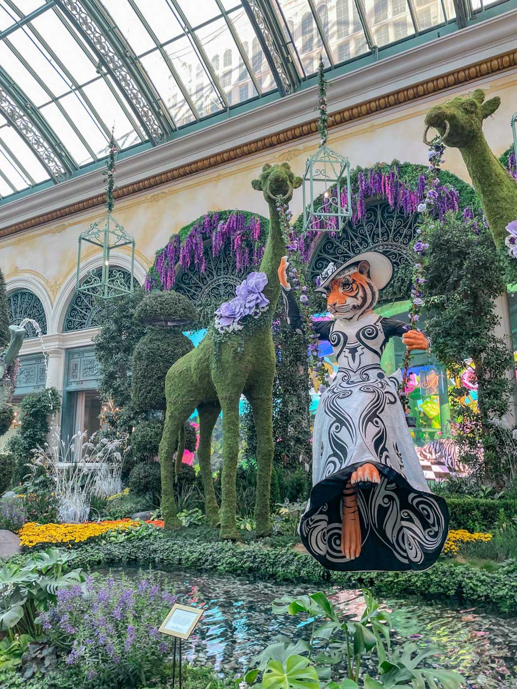 Plants, animal-shaped plants, and animal art inside an indoor garden in Las Vegas.