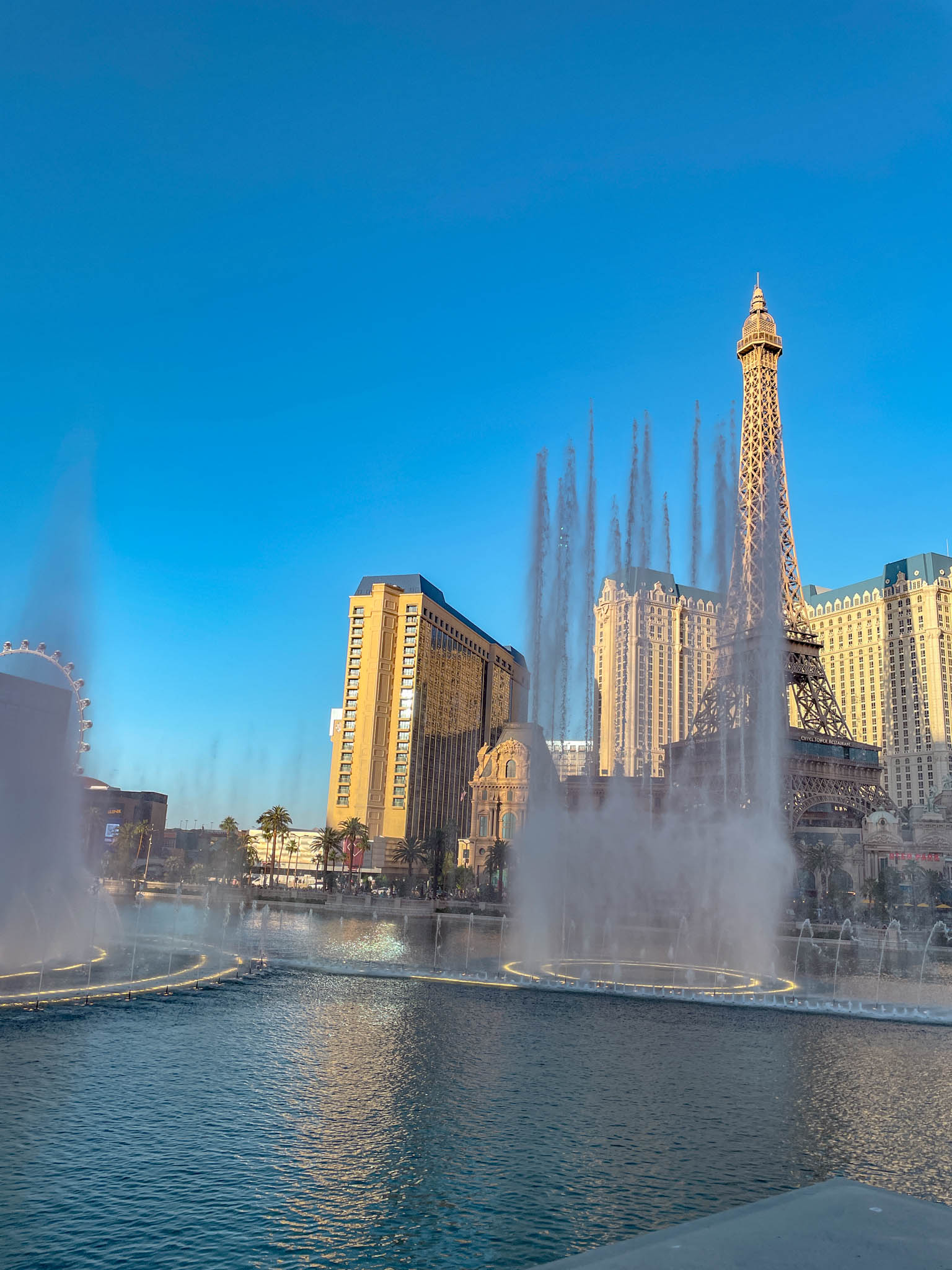Bellagio Fountains in front of a replica of the Eiffel Tower in Las Vegas.