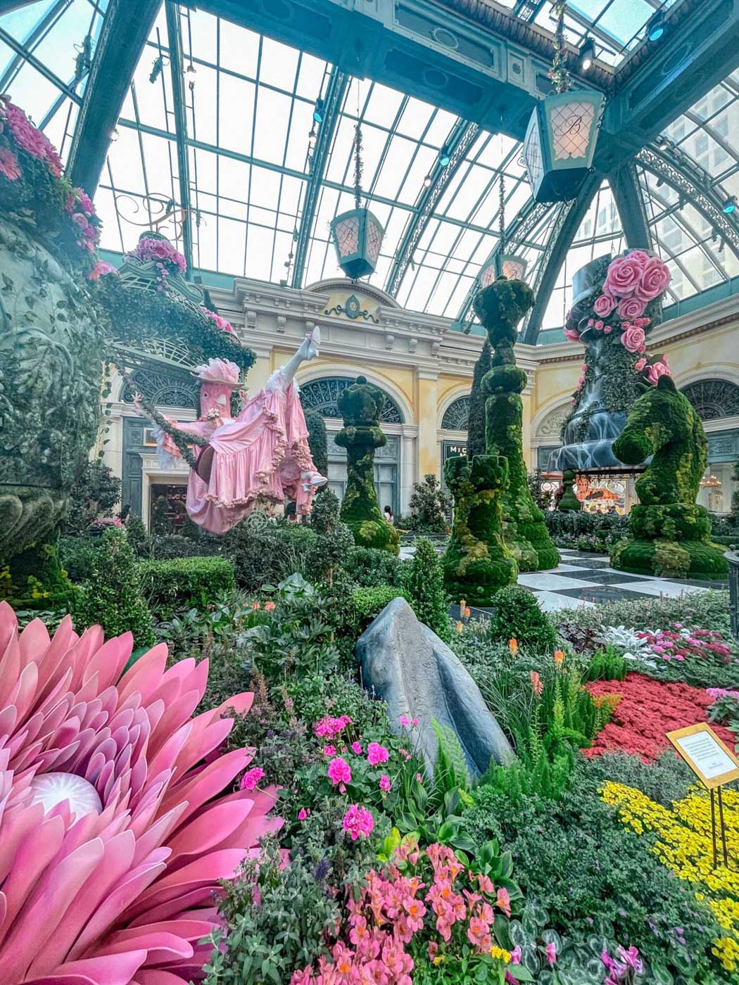 Flowers and plant installations inside an indoor botanical garden in Las Vegas.