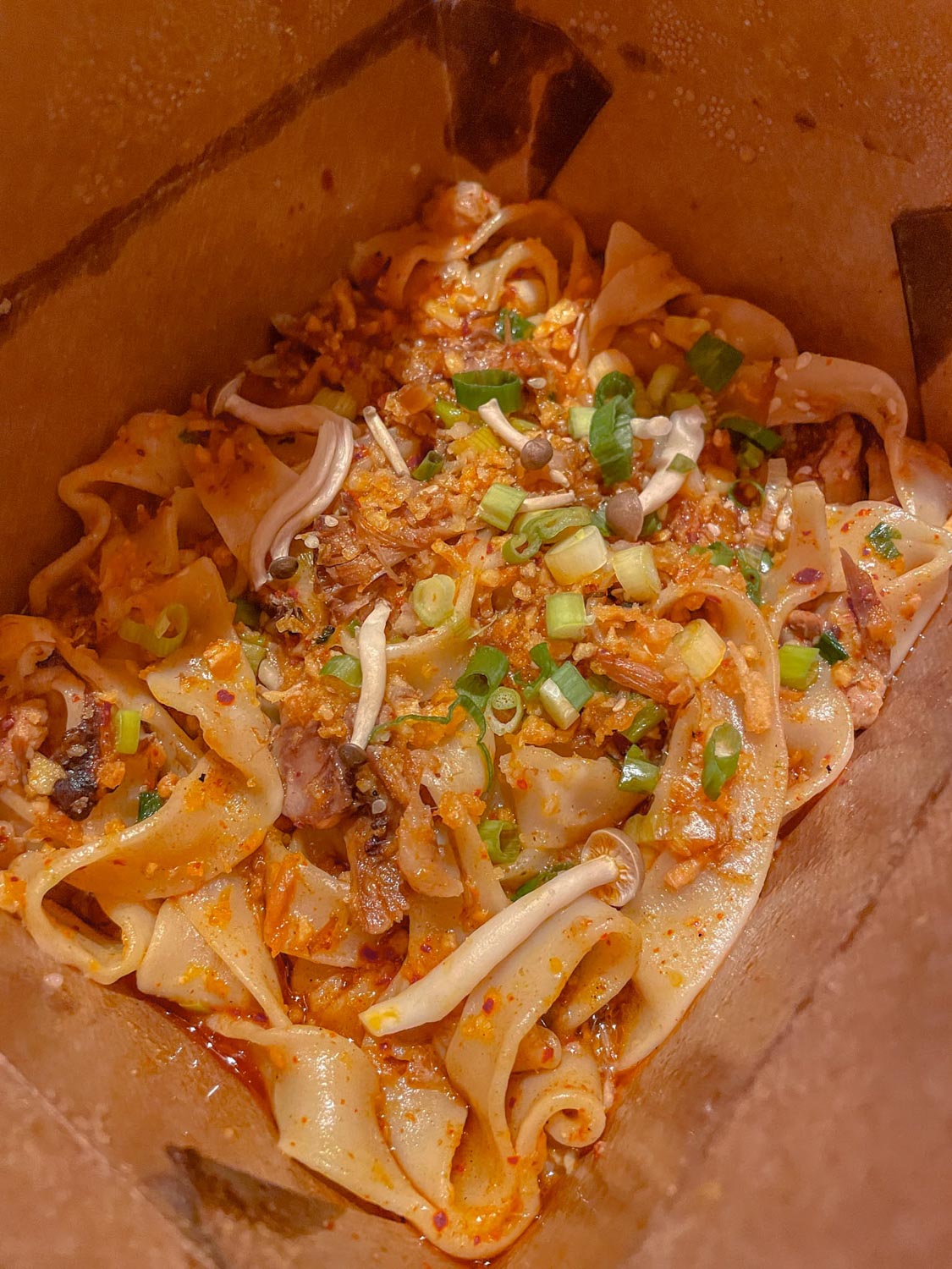 Noodle dish in a takeout container.