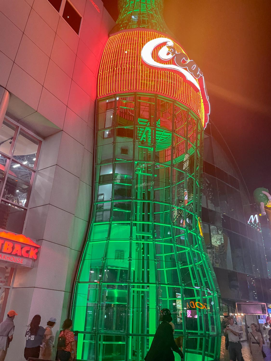 A giant coca cola bottle with neon lights.