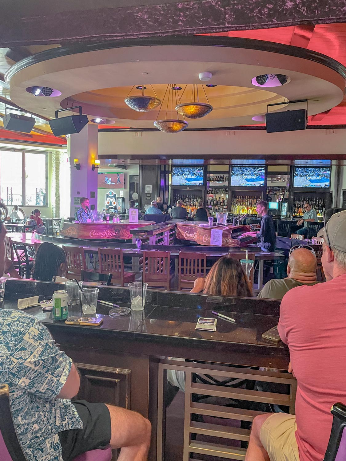 People hanging out in a hotel bar during the day.