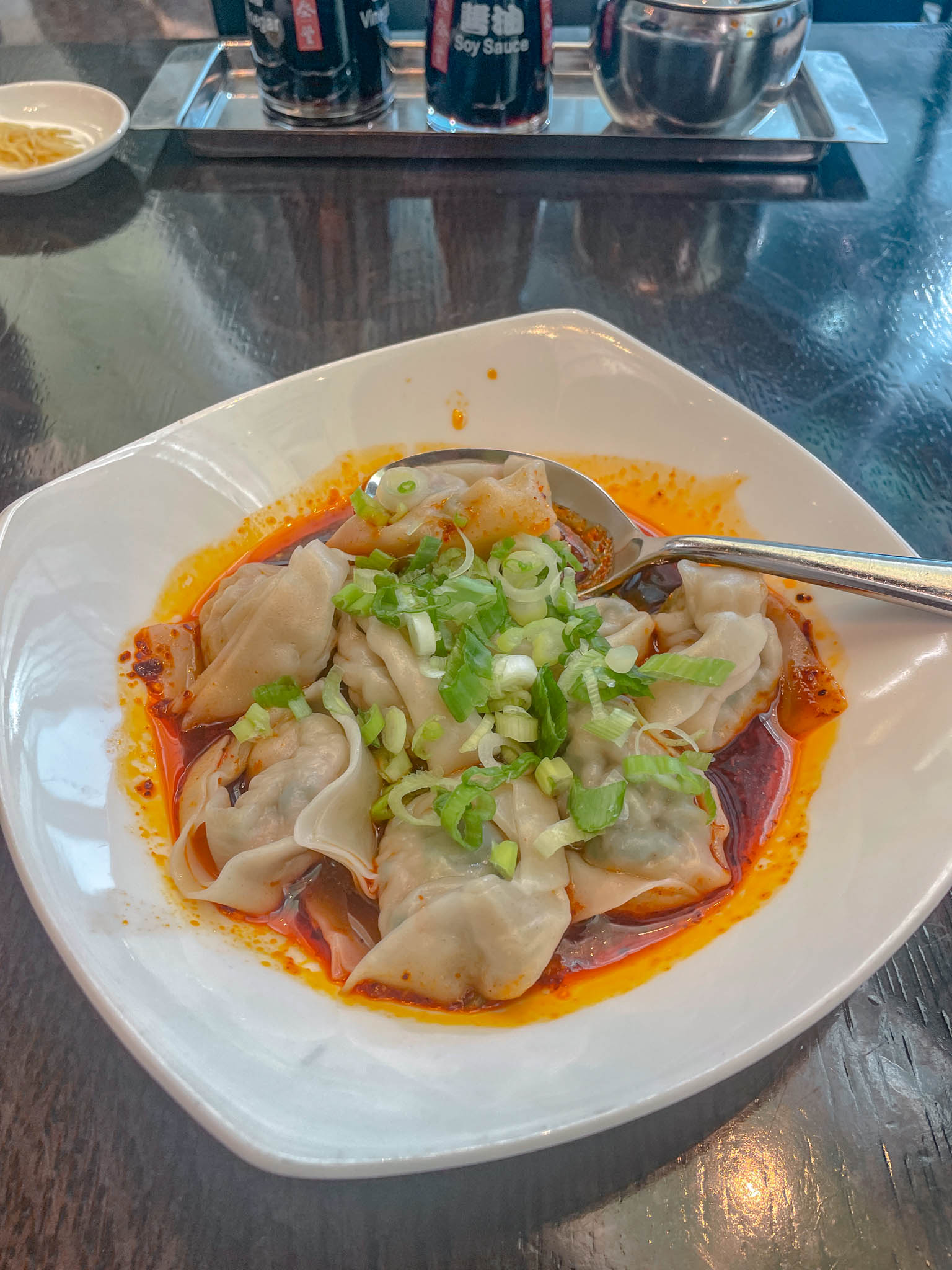 A bowl of spicy dumplings.