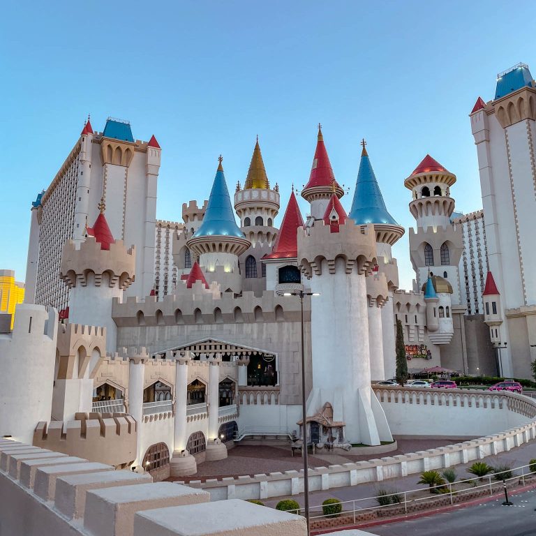 A hotel building with castle-like exteriors Excalibur Las Vegas review.