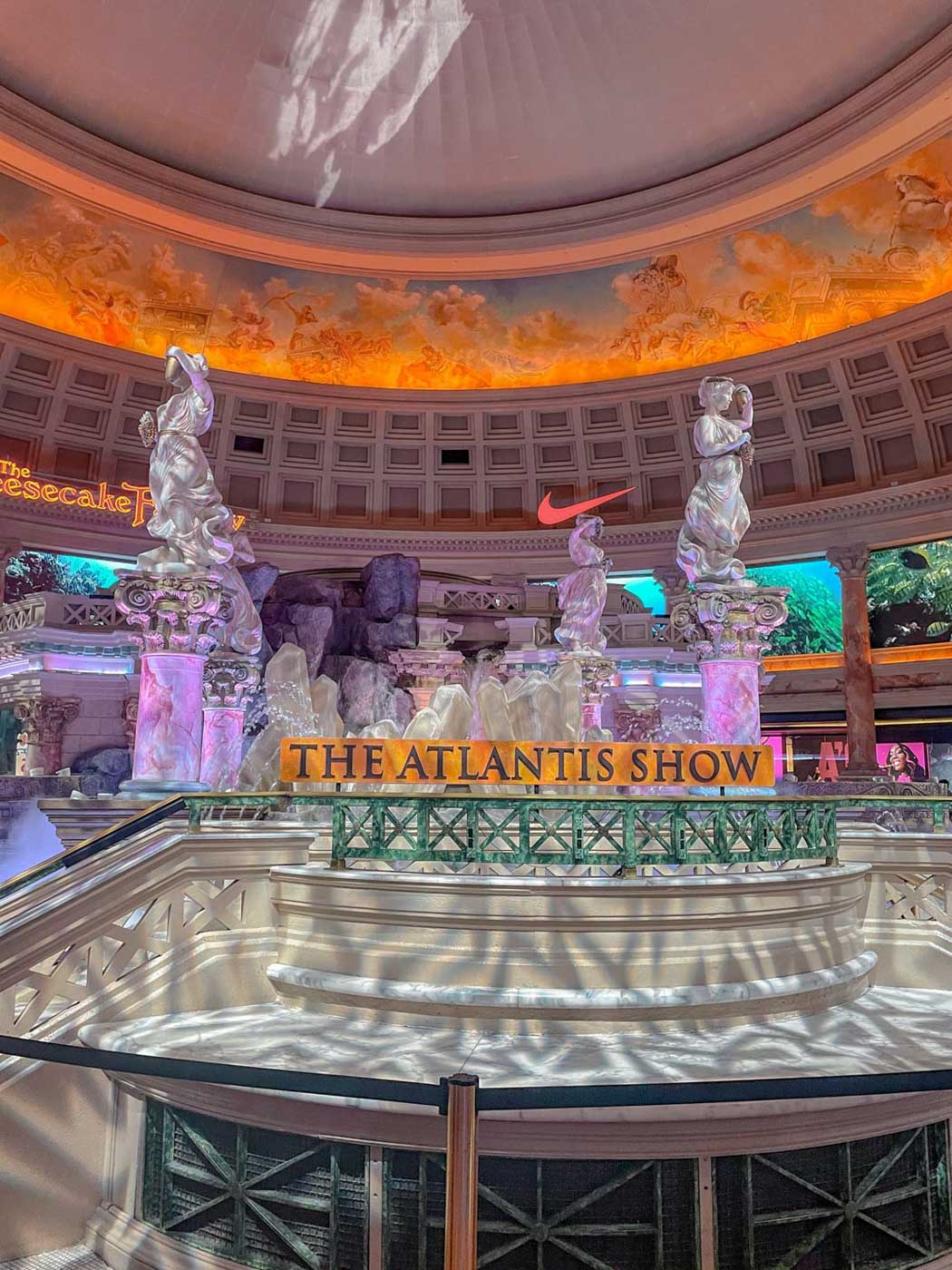 Elegant statues inside a hotel in Las Vegas and text that says "The Atlantis Show".