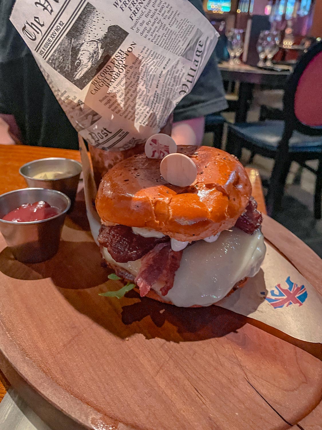 Burger on a wooden plate.