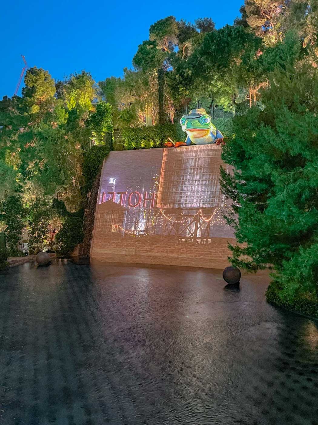 An outdoor multimedia show featuring lights, music, projections, and special effects on a scenic lake behind the resort at night.