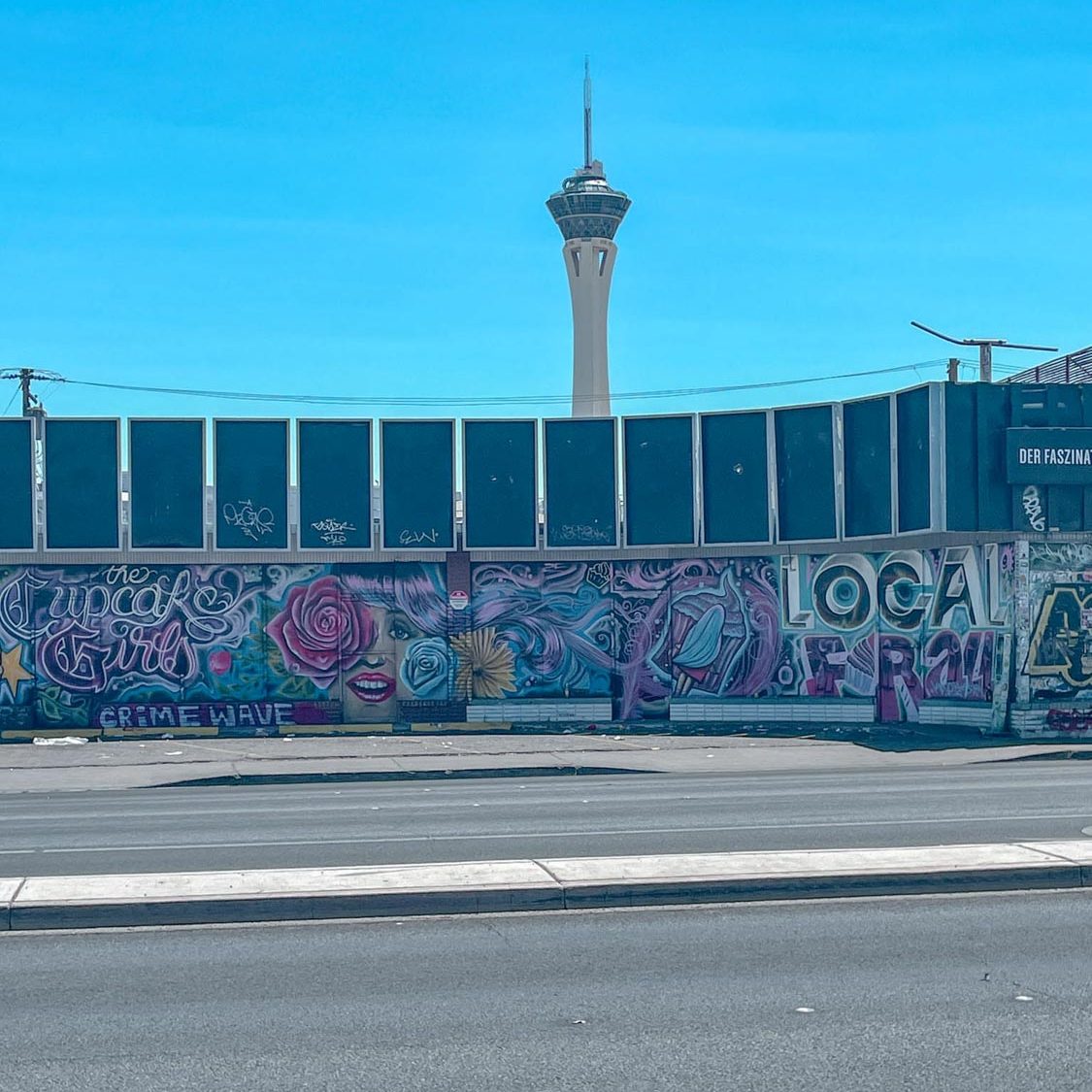 Colorful mural on a wall in Las Vegas with a view of a tower in the background.