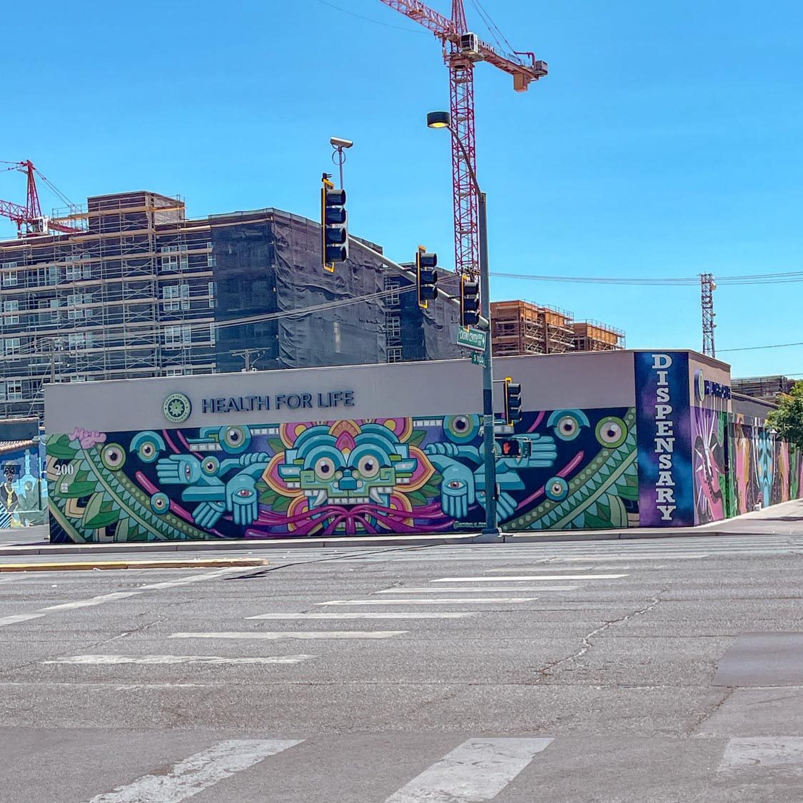 Colorful mural on a wall in Las Vegas with a view of buildings in the background.