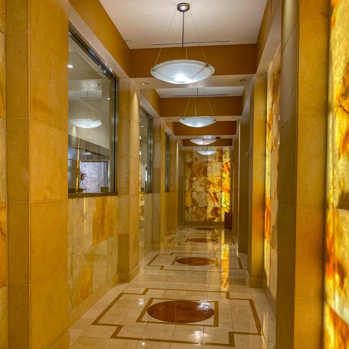 The hallway of a spa with yellow lighting.