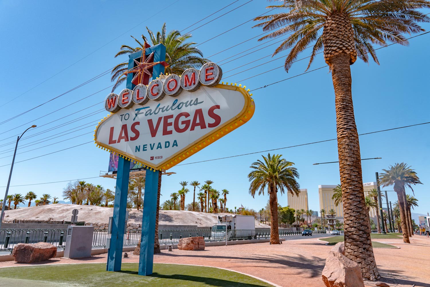 A big sign that says "Welcome to fabulous Las Vegas Nevada" between two palm trees.