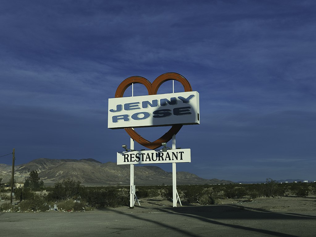 A sign that says "Jenny Rose Restaurant" with red heart on the road.