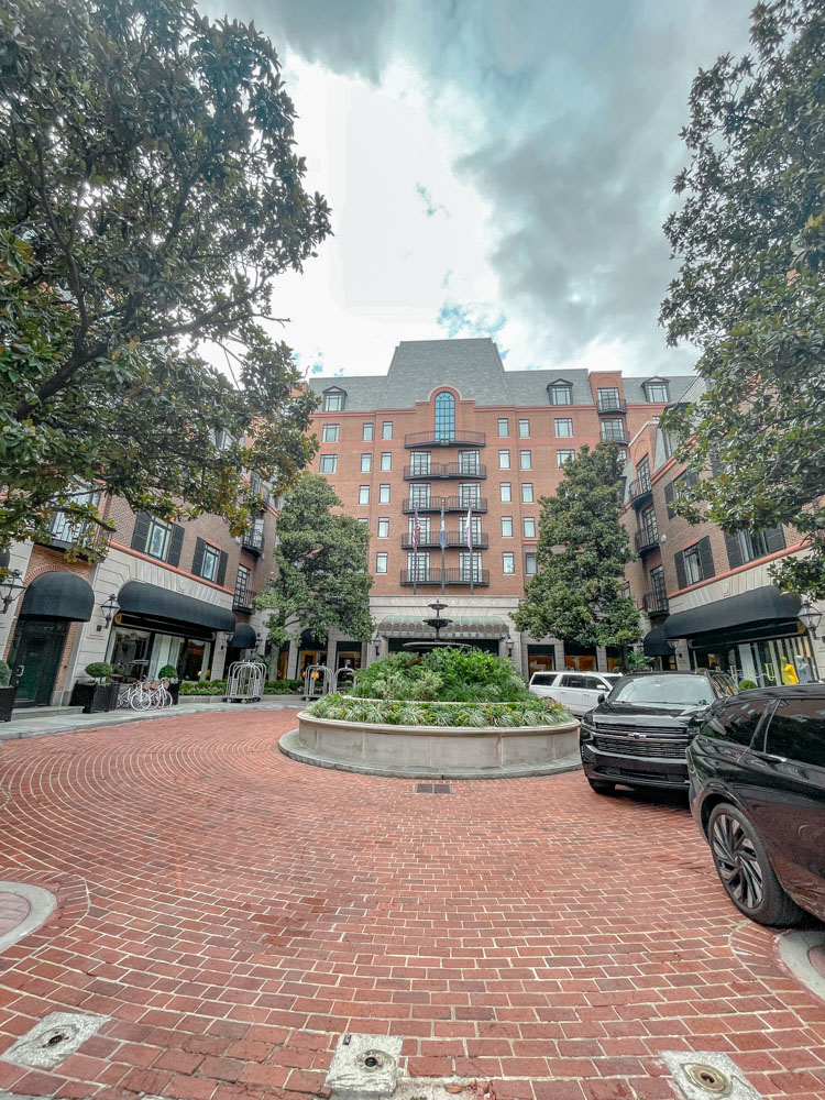 The front of a hotel with brick flooring in Charleston, South Carolina.