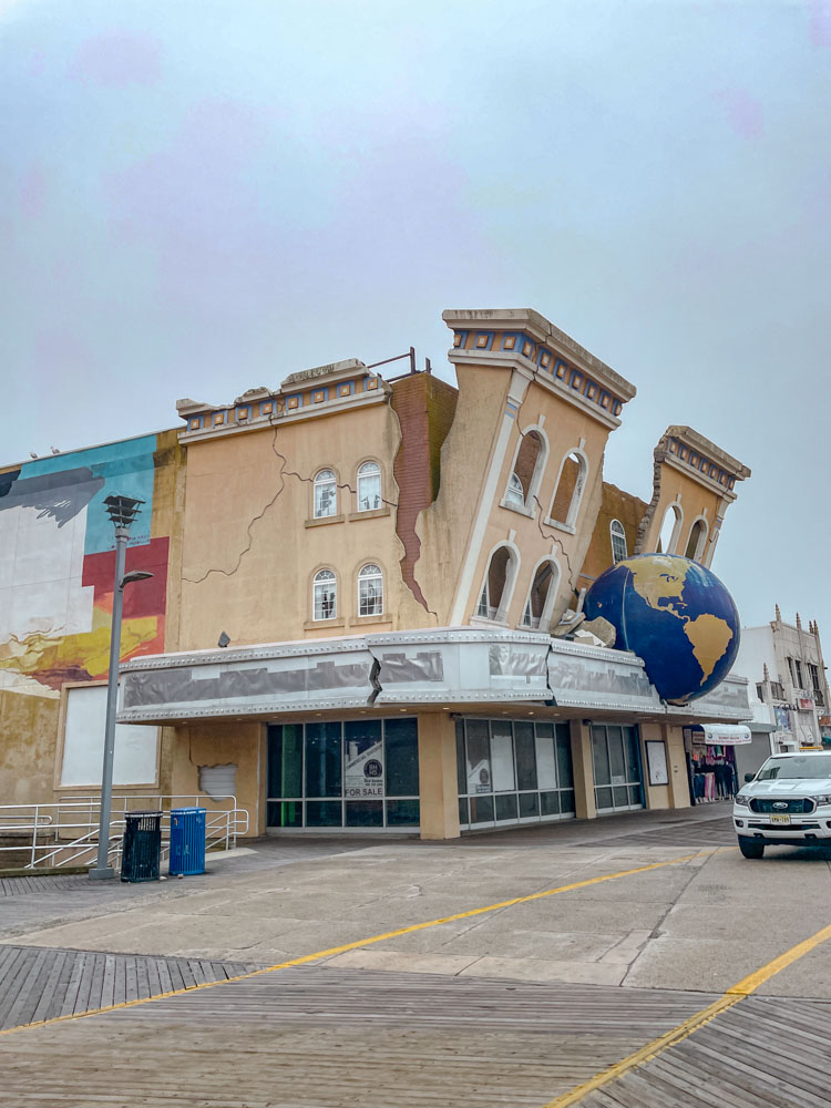A unique building in Atlantic City with cracks and a globe.