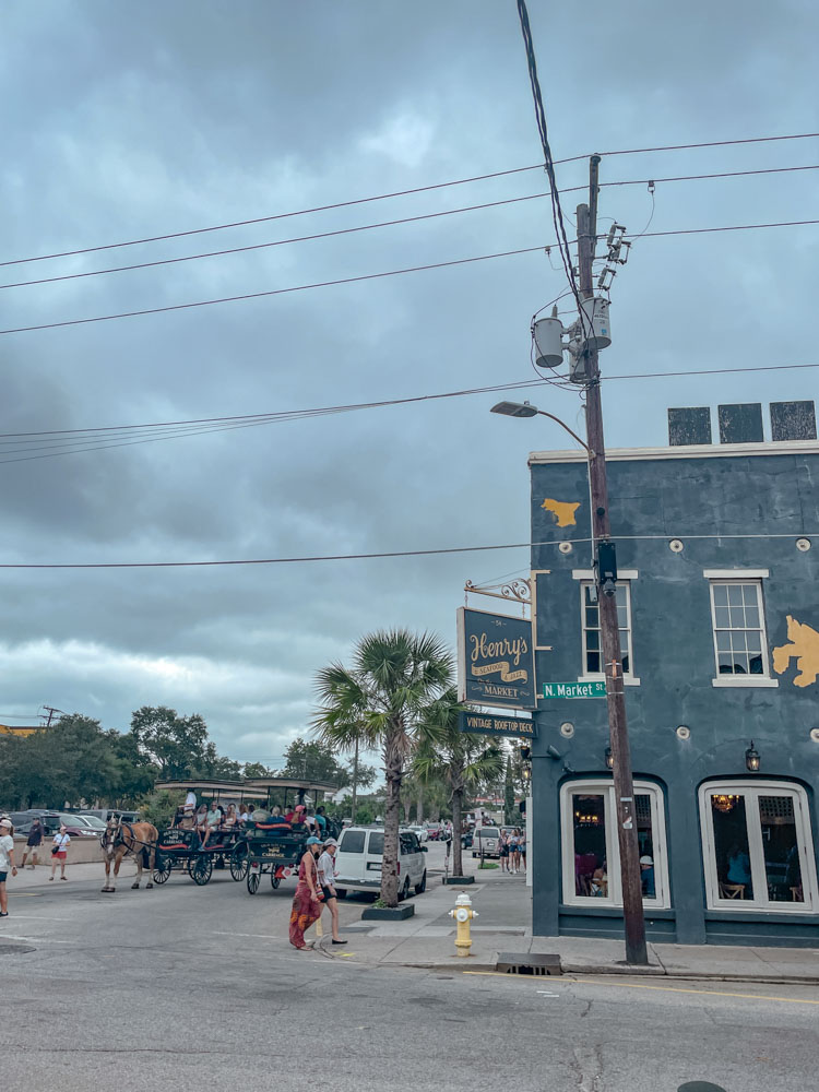 People walking and riding carriages in Charleston, South Carolina.
