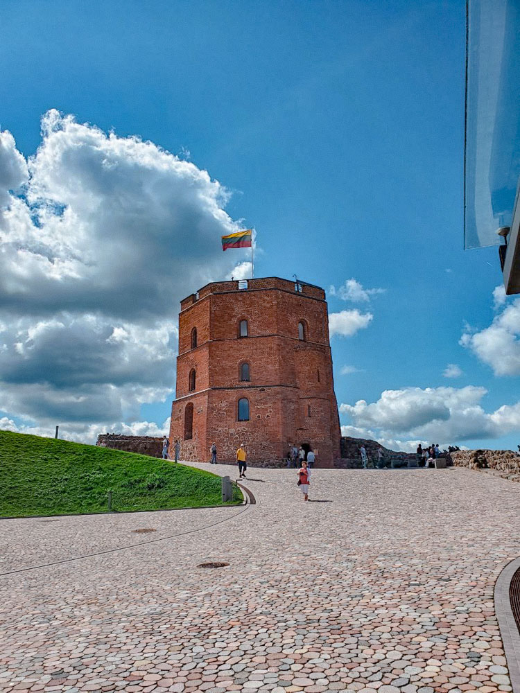 People walking near Gediminas Castle in Vilnius, Lithuania.