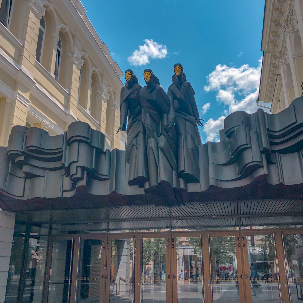 Sculptures on top of a restaurant window in Old Town Vilnius.