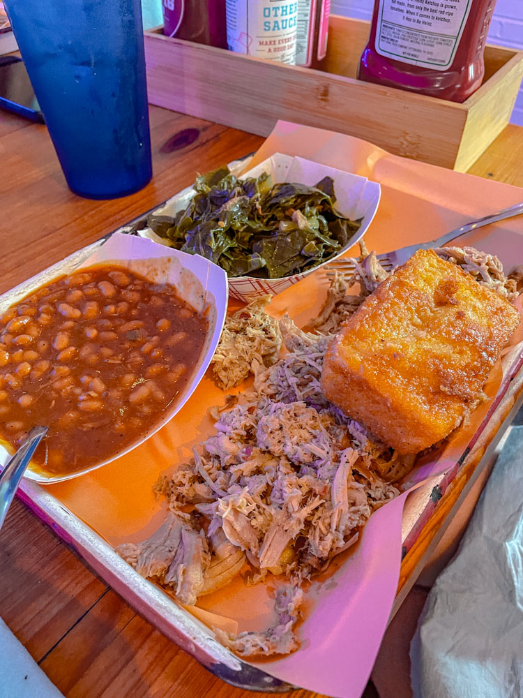 A spread of food, including beans vegetables, bread, and meat.