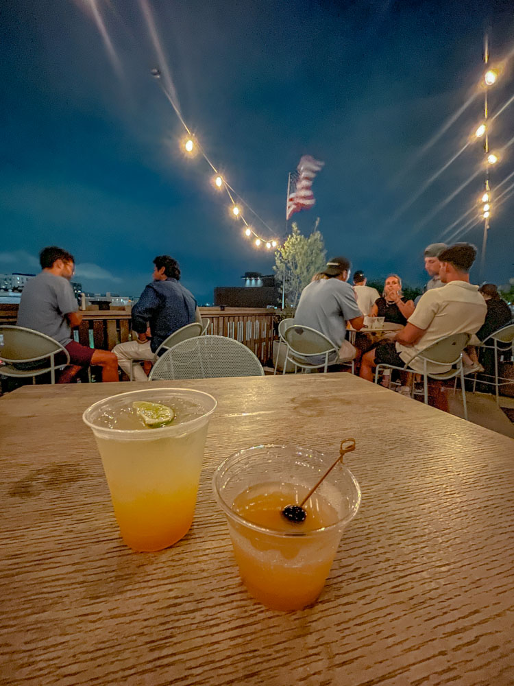 Drinks in a cup on a table at a rooftop bar in Charleston, South Carolina.
