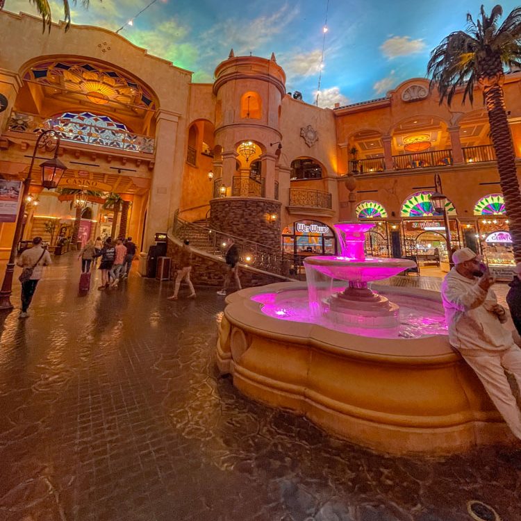 Inside Tropicana hotel in Atlantic City with restaurants and fountain.