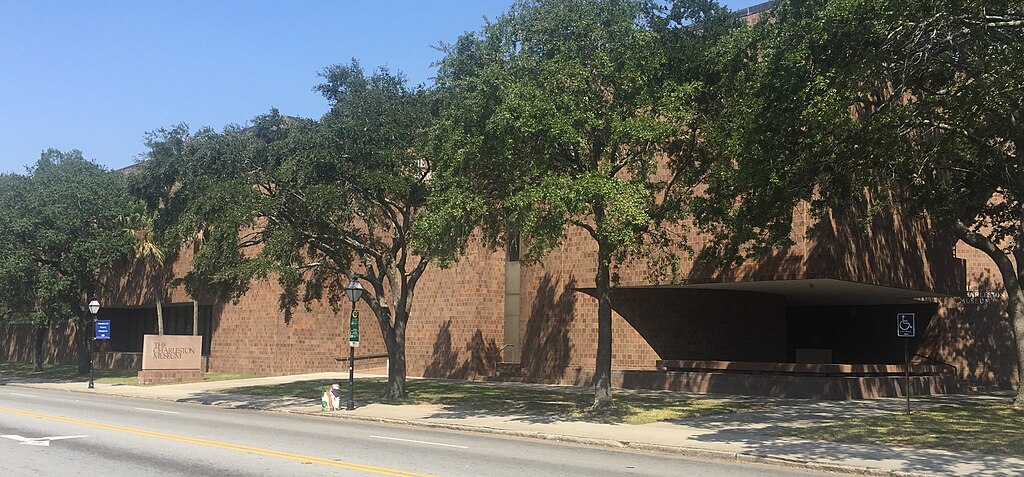 The front of The Charleston Museum with bricks and surrounded by trees in Charleston, South Carolina.