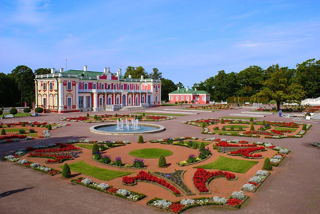 A palace with a fountain and colorful flowers in Tallinn, Estonia.