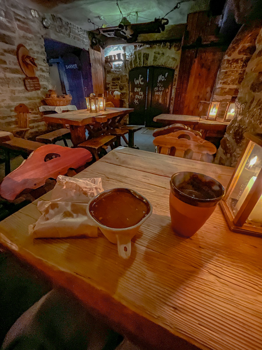 Medieval-style pub in Tallinn, Estonia with wooden tables and chairs.
