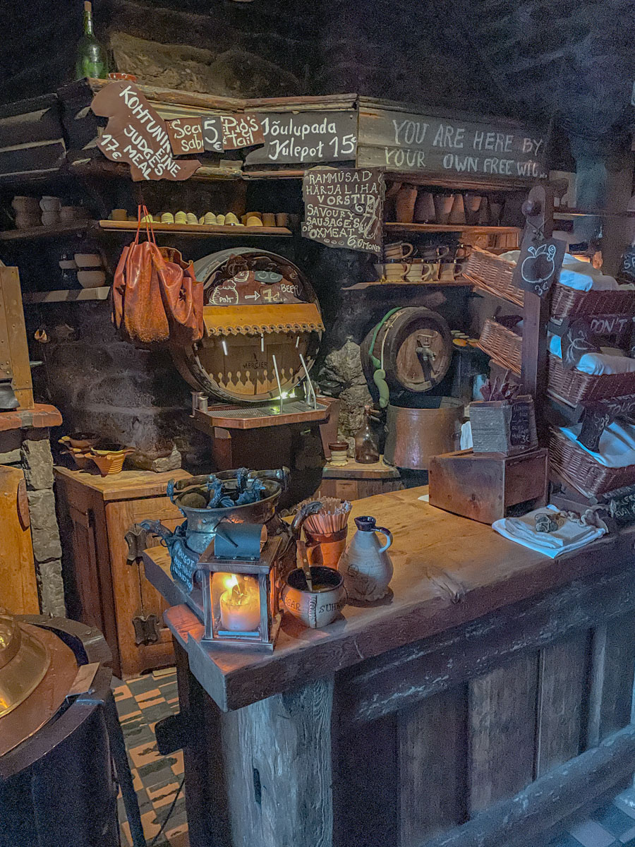 Medieval-style pub in Tallinn, Estonia with wine barrels and shelves.