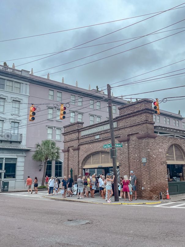 People waiting for the stop light on a sidewalk in Charleston, South Carolina.