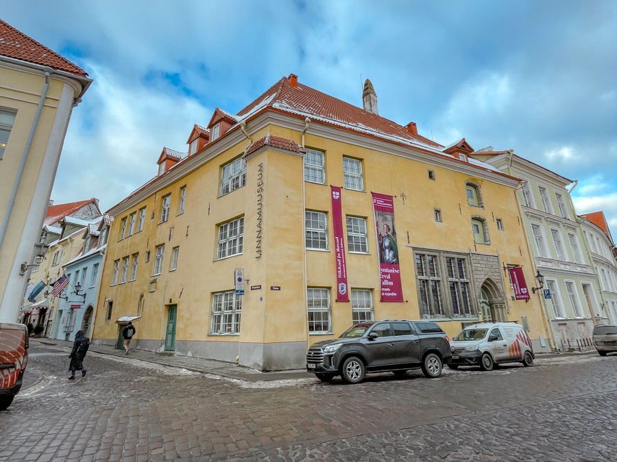 The corner of a museum's yellow building.