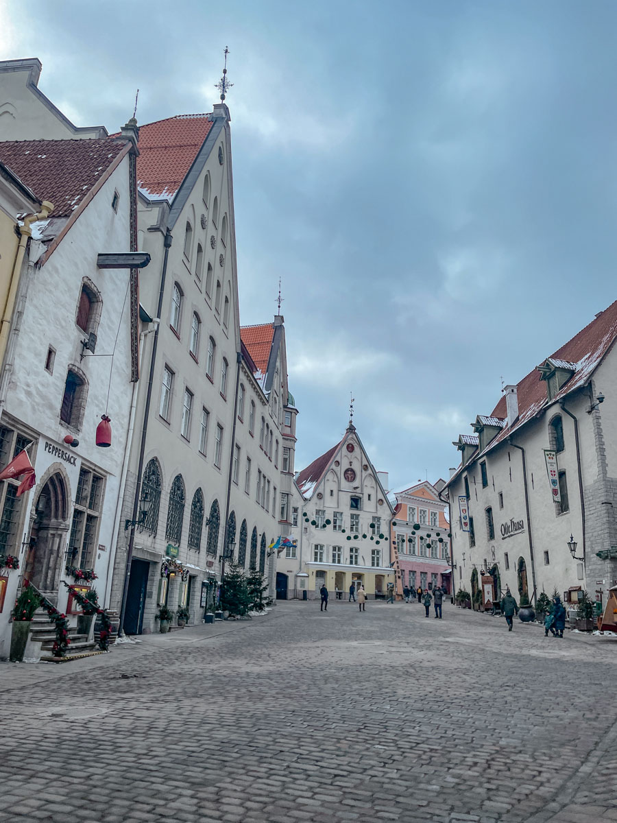 Cobblestone streets surrounded by Medieval buildings in Tallinn, Estonia.